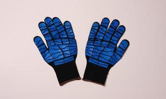 Knitted gloves with embossed latex coating to protect against mechanical damage and cuts. photo