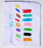 Multi-colored marker swatches on checkered paper photo