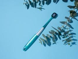 Plastic toothbrush on a blue background photo