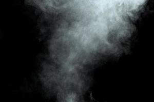 Abstract  powder or smoke isolated on black background photo