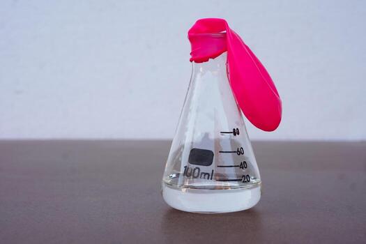 Science experiment, flat pink balloon with no air on top of transparent test bottle. First step of the experiment about air or gas reaction.by using baking soda and vinegar.Concept,  Science Education photo