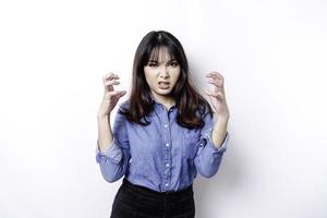 A portrait of an Asian woman wearing a blue shirt isolated by white background looks depressed photo