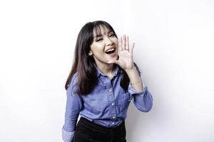 Young beautiful woman wearing a blue shirt shouting and screaming loud with a hand on her mouth. communication concept. photo