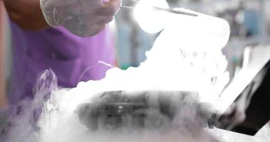 Hands of young veterinarian man in uniform pouring liquid nitrogen into temperature controlled tank for collect animal sperm, Frozen stem cells in containers video