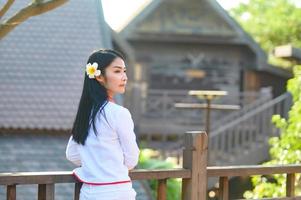 Asian woman wearing typical thai dress with red umbrella.,Thai costume photo