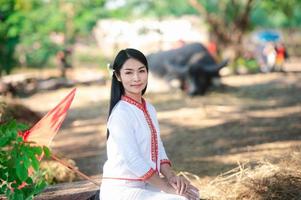 Asian woman wearing typical thai dress with red umbrella.,Thai costume photo