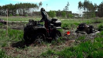 team race through the swamp on an ATV video