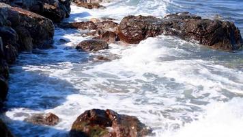 waves of the sea on the rocky beach video