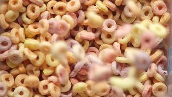 Extreme close up on falling colorful ring puff cereal video