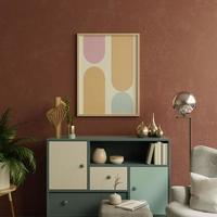 maqueta de marco de imagen en tonos cálidos con sillón y decoración mínima. foto