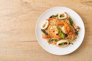 stir-fried Chinese noodle with basil, chilli, shrimps and squid photo