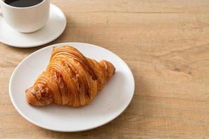 fresh croissant on white plate photo