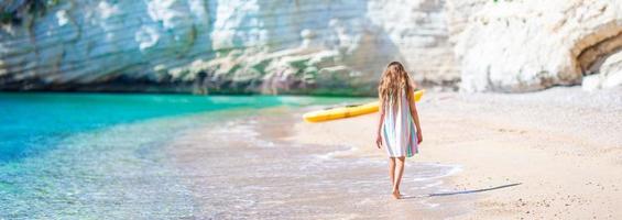 Cute little girl at beach during summer vacation photo