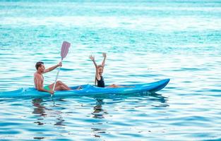 Sporty attractive family kayaking on sea together photo