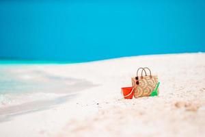 Beach accessories - straw bag, hat and unglasses on the beach photo