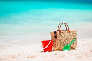 Beach accessories - straw bag, hat and unglasses on the beach photo