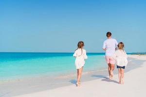 Happy beautiful family on a tropical beach vacation photo