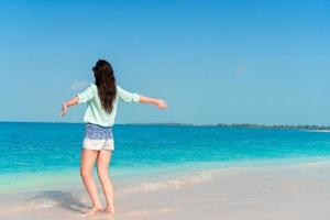 Woman laying on the beach enjoying summer holidays looking at the sea photo