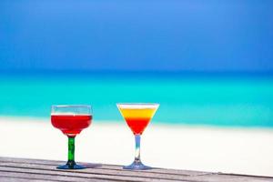 Two tasty cocktails on tropical white beach photo