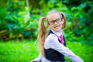 Little happy girl going back to school outdoor photo