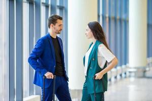 Tourists couple with baggage in international airport. Man and woman going on landing photo