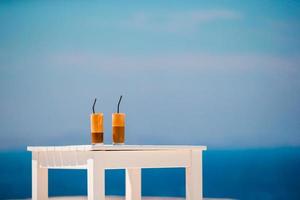 Frappe, ice coffee on the beach. Summer iced coffee frappuccino, frappe or latte in a tall glass background the sea in beach bar photo