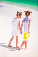 Little adorable girls during tropical beach vacation photo