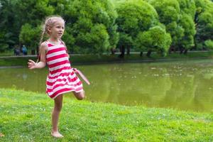 Cute little girl playing badminton on picnic photo