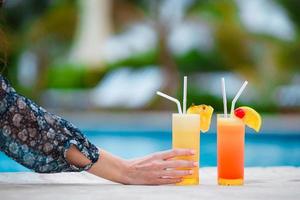Two tasty cocktails on tropical white beach photo