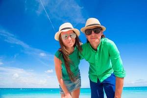 Young happy couple on white beach at tropical vacation photo