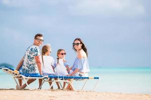 Happy family on the beach during summer vacation photo