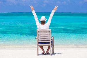 Young man enjoying summer vacation on tropical beach photo