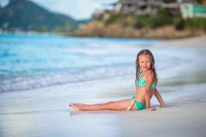 Adorable little girl on the beach during summer vacation photo