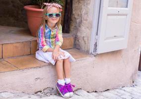 Adorable little girl outdoors in European city photo