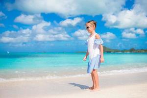 Cute little girl at beach during caribbean vacation photo