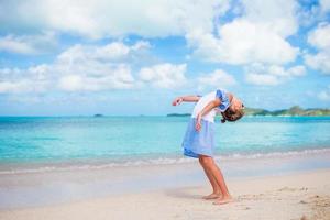 Cute little girl at beach during caribbean vacation photo