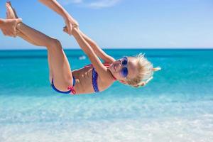 Happy little girl have fun during summer beach vacation photo