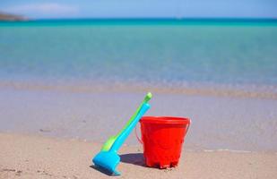 Summer kid's beach toys in the white sandy beach photo