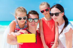 Young family taking selfie portrait on the beach photo