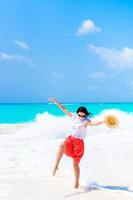 Young beautiful woman on tropical white beach photo