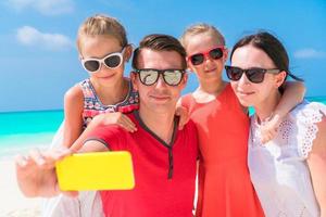 Young beautiful family taking selfie portrait on the beach photo