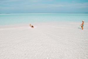 Little girl and young mother during beach vacation photo