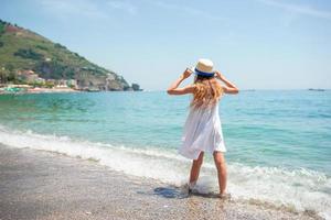 Cute little girl at beach during summer vacation photo