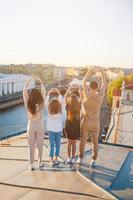 Family on rooftop enjoying with view of beautiful sunset in Sankt Petersburg in Russia photo