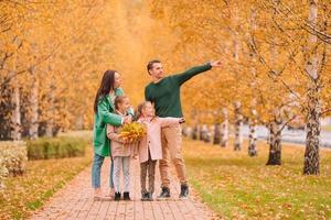 Portrait of happy family of four in autumn photo