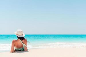 Young fashion woman in green dress on the beach photo