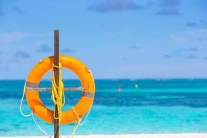 Lifebuoy ring on tropical white beach photo