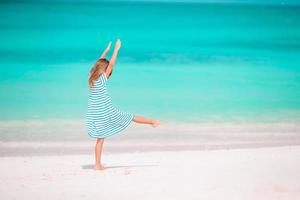 Adorable little girl at beach on her summer vacation photo