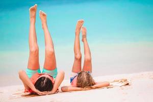 Beautiful mother and daughter at Caribbean beach enjoying summer vacation. photo