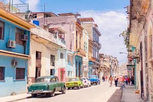 Authentic view of a street of Old Havana with old buildings and cars photo